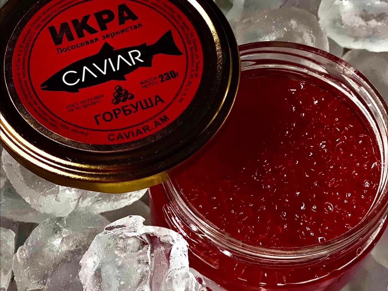 Caviar.am salmon roe in a glass jar on ice